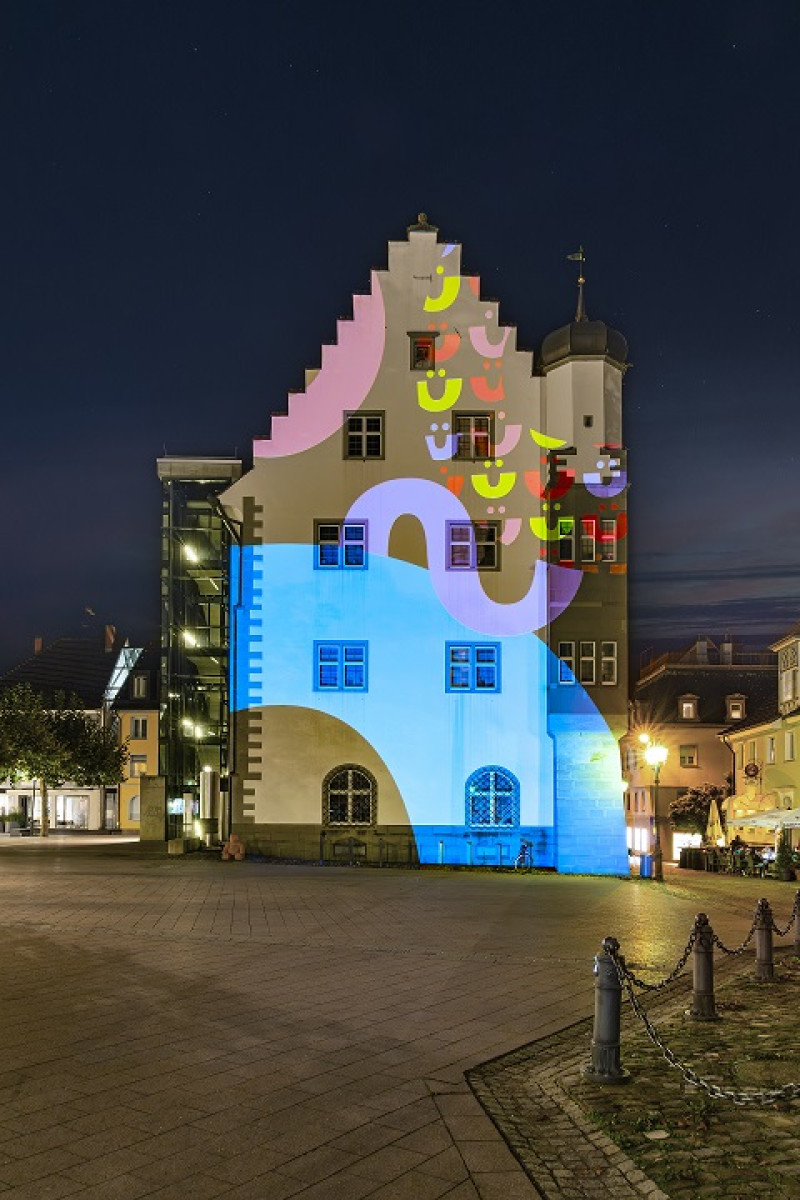 Farbenfrohe Projektionen auf historischem Gebäude in Deutschland. Kunstinstallation bei Nacht, architektonische Beleuchtung.